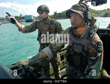 Royal Thai and U.S. Navy personnel work together. Stock Photo