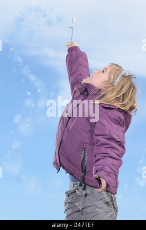Girl child playing with a magic wand Stock Photo