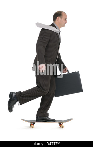 Fast businessman on skateboard Stock Photo