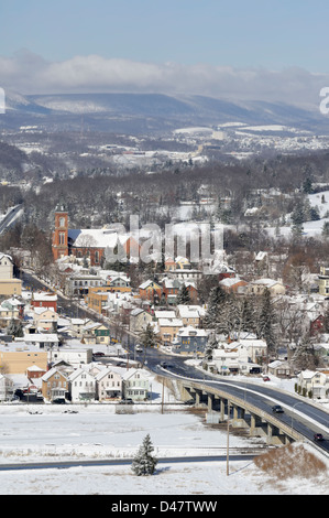American mountain town in a snowy landscape, aerial done on a sunny day from an Indian lookout, showing a church and a highway. Stock Photo