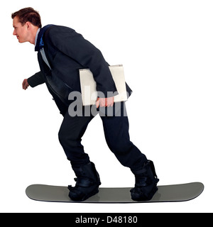 A young man in office clothes, carrying a laptop, riding his snowboard to work. Or anyone hurring to get somewhere fast. Stock Photo