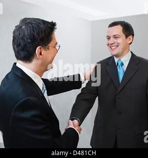 a warm friendly handshake between two businessmen, or a manager telling a job applicant "welcome to the team" Stock Photo