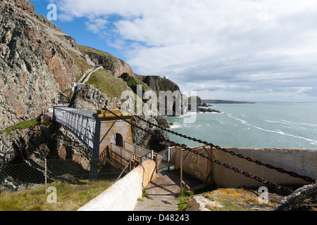The iron suspension bridge that connects South Stack lighthouse to the mainland in Angelsey, Wales Stock Photo