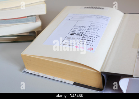 Library book open on first page with return dates stamped Stock Photo