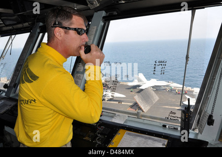 Officer watched flight deck from Primary. Stock Photo