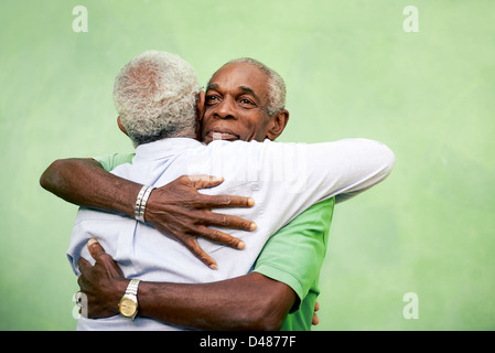 Active retired old men and leisure, two senior black brothers hugging outdoors Stock Photo