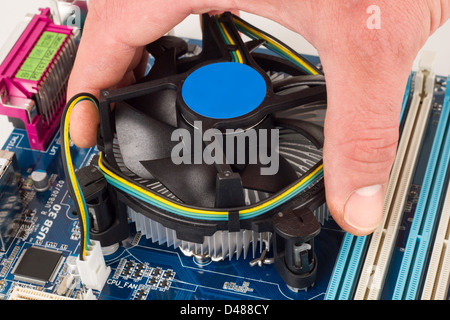 Cpu cooler installation on a mainboard Stock Photo