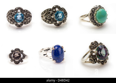 Gemstone ring collection. Collection of faceted cut Blue Topaz, Smokey Quarts, Mystic Topaz, Lapis Lazuli, and Turquoise rings Stock Photo