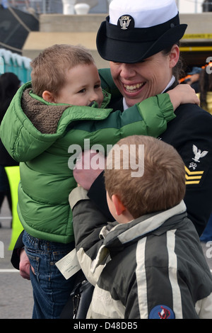 A Sailor greets her family after deployment. Stock Photo