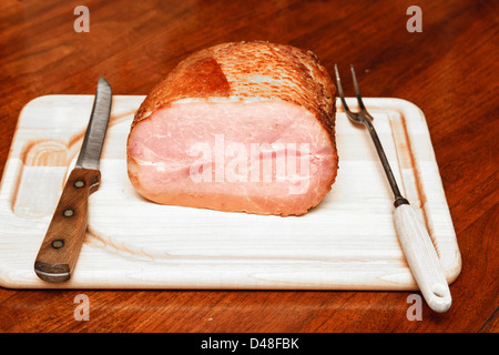 A nice sliced ham on a wood cutting board Stock Photo