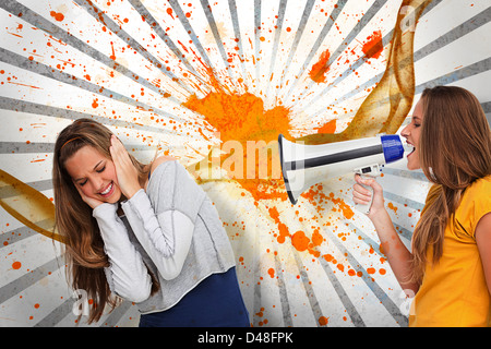 Girl shouting at her friend through a megaphone Stock Photo