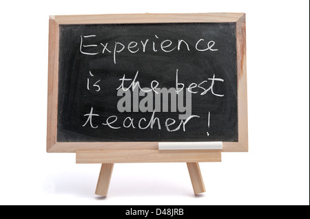 "Experience is the best teacher" saying written on blackboard over white background Stock Photo