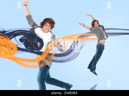 Two of the same young man jumping for joy Stock Photo