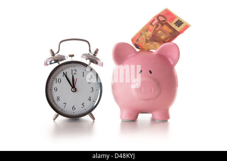 Alarm clock and piggy bank with fifty euro sticking out