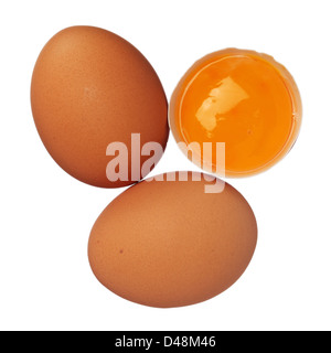 Whole eggs and egg yolk in shell isolated on white Stock Photo