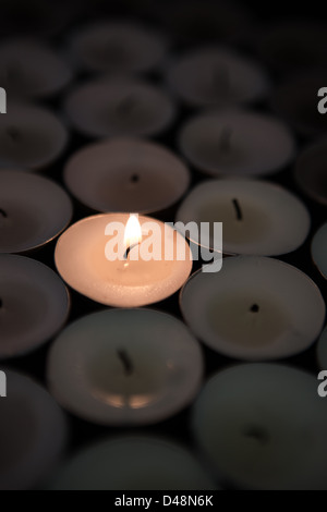 Single candle lighting in the dark Stock Photo