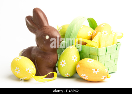 Easter eggs in a basket with chocolate bunny Stock Photo