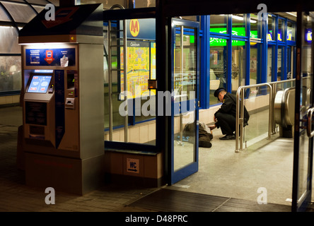 Warsaw, Poland, Security takes care of a drunken man in a subway station Stock Photo