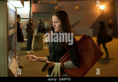 Warsaw, Poland, a young woman from the ticket machine Stock Photo