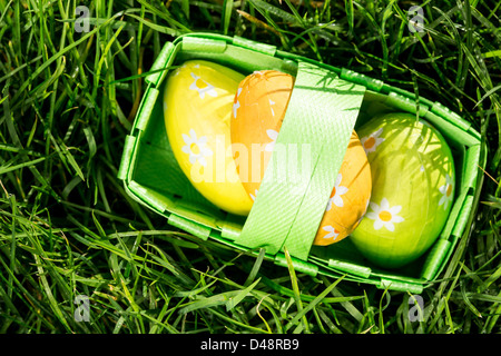 Three easter eggs in a basket Stock Photo