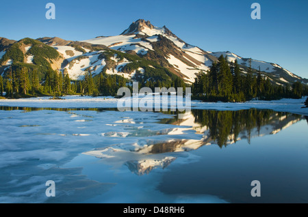 Mount Jefferson seen from ice covered Russell Lake in Jefferson Park, Mount Jefferson Wilderness, Oregon Stock Photo