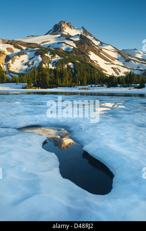 Mount Jefferson seen from ice covered Russell Lake in Jefferson Park, Mount Jefferson Wilderness, Oregon Stock Photo