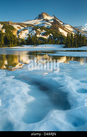 Mount Jefferson seen from ice covered Russell Lake in Jefferson Park, Mount Jefferson Wilderness, Oregon Stock Photo