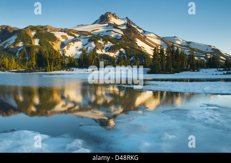 Mount Jefferson seen from ice covered Russell Lake in Jefferson Park, Mount Jefferson Wilderness, Oregon Stock Photo