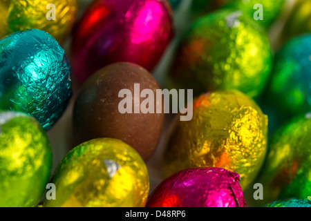 Colourful easter eggs with one unwrapped Stock Photo
