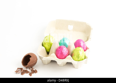 Carton of easter eggs with one broken on surface Stock Photo