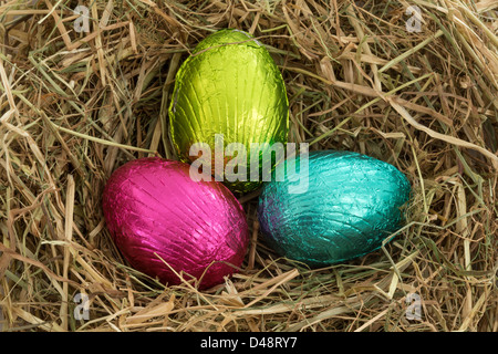 Three easter eggs nestled in straw Stock Photo