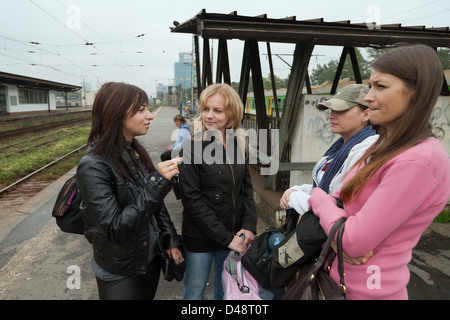 Warsaw, Poland, four women waiting on a train platform Stock Photo