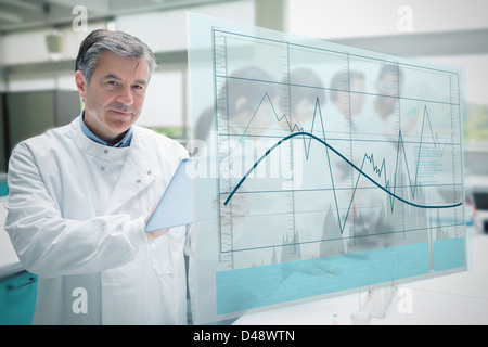 Confident scientist working with tablet and futuristic interface showing graph Stock Photo