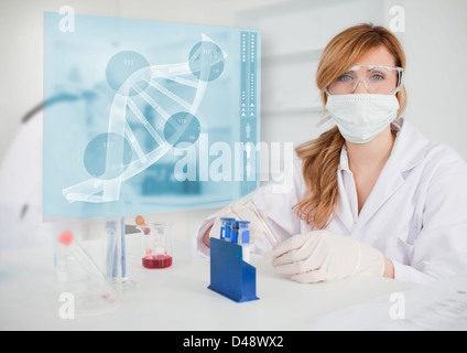 Chemist working in the lab with futuristic interface Stock Photo