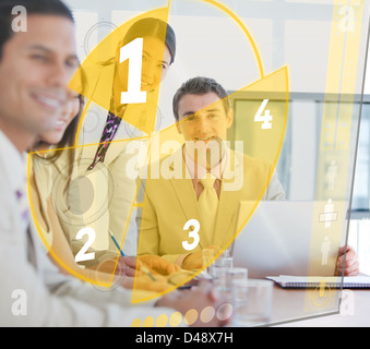 Business people using pie chart interface Stock Photo