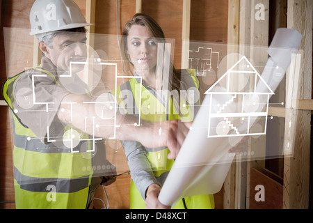 Architect and foreman looking at the plans on interface Stock Photo