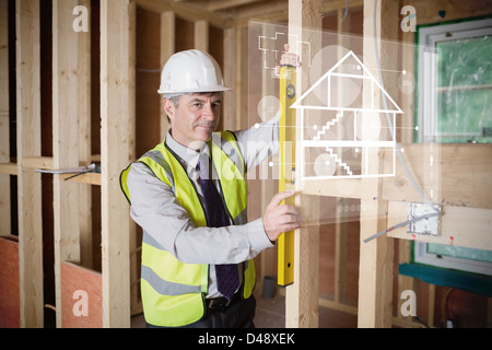 Architect using spirit level and looking at white hologram interface Stock Photo