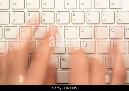 Hand typing on keyboard Stock Photo