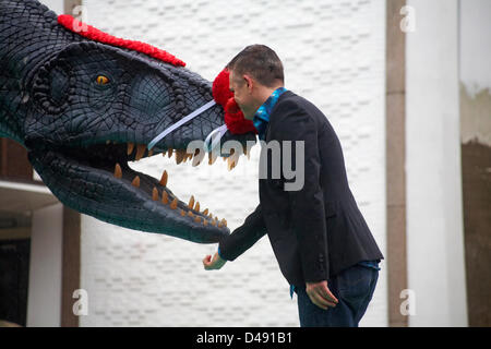 Bournemouth, UK. 8th March 2013. COMEDY Darren the dinosaur is released onto the streets of Bournemouth in aid of Comic Relief. Darren the dinosaur is three metres tall by eight metres long and was used in Walking with Dinosaurs, He was set free by celebrity Chris Jarvis from outside the BIC. The event was organised by Sainsbury's to encourage people to call into any store to get their red noses to protect themselves should they see the prehistoric creature while out and about. Credit:  Carolyn Jenkins / Alamy Live News Stock Photo