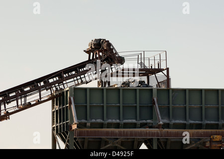 Detail of a conveyor belt filling a stone crusher Stock Photo