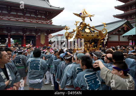 Gold decorated sacred mikoshi portable shrine carried around Sensoji Temple Hozomon Gate during Sanja Matsuri Festival. Stock Photo