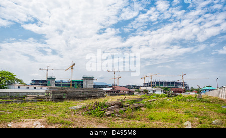 buildings under construction with cranes against cloud and blue sky Stock Photo