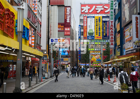 Neon signs and advertising on building facades fill skyline in consumer electronics district Akihabara in Tokyo Stock Photo