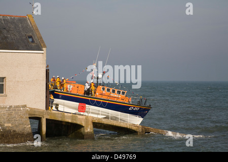 Moelfre Isle of Anglesey North Wales Vicar and Crew boarding RNLI lifeboat on station slipway awaiting final launch before being replaced by newer boa Stock Photo