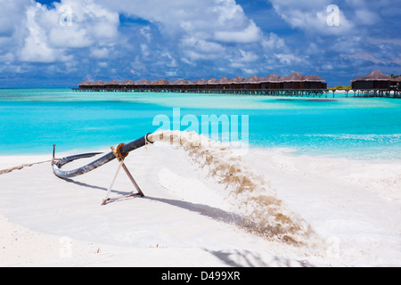 Beach nourishment to replace sand eroded by waves and storms Stock Photo