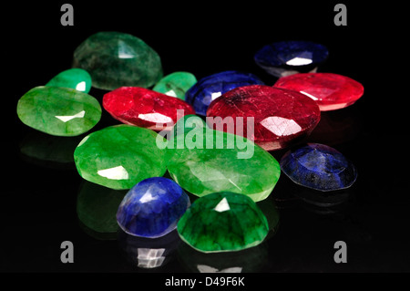 Low grade (opaque) Rubies, Sapphires and Emeralds - faceted Stock Photo