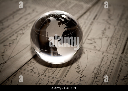 Globe showing North America and resting on financial papers Stock Photo