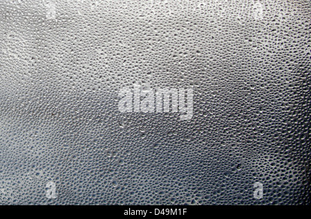 Warm air condensing on a cold window pane Stock Photo
