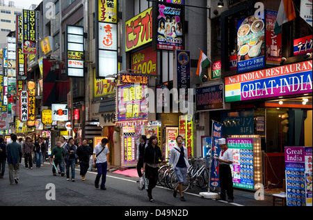 Neon advertising signs cover building facades in shopping and adult entertainment district Kabukicho in East Shinjuku, Tokyo Stock Photo