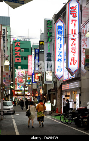 Neon advertising signs cover building facades in shopping and adult entertainment district Kabukicho in East Shinjuku, Tokyo Stock Photo